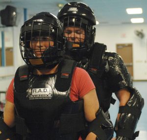 A Rape Aggression Defense (R.A.D.) instructor prepares to run an attack simulation with a student during a R.A.D. class. R.A.D. is designed to teach self-defense and preventative measures against sexual assaults and other attacks.