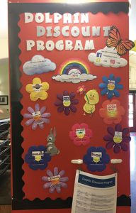 A photo of the Dolphin Discount Program (DDP) board in the Student Union. The DDP provides CI students with various discounts from local businesses. Photo credit to Ivey Mellem.